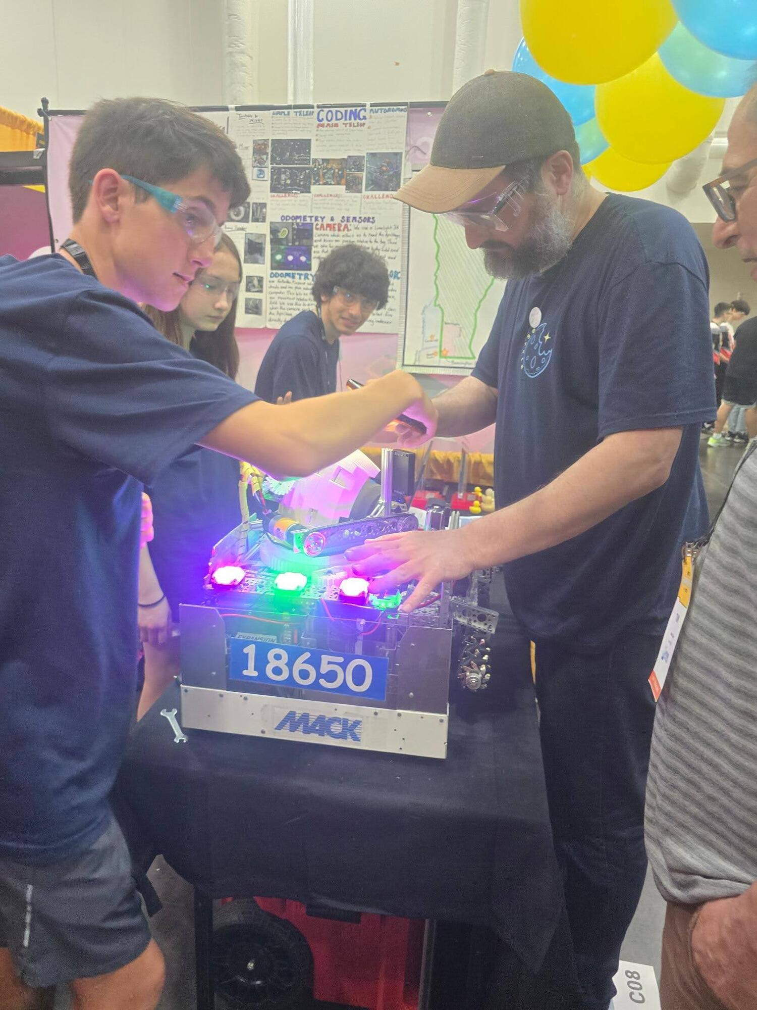 Team 18650 repairing the robot in the pit at FIRST Championship Houston 2026